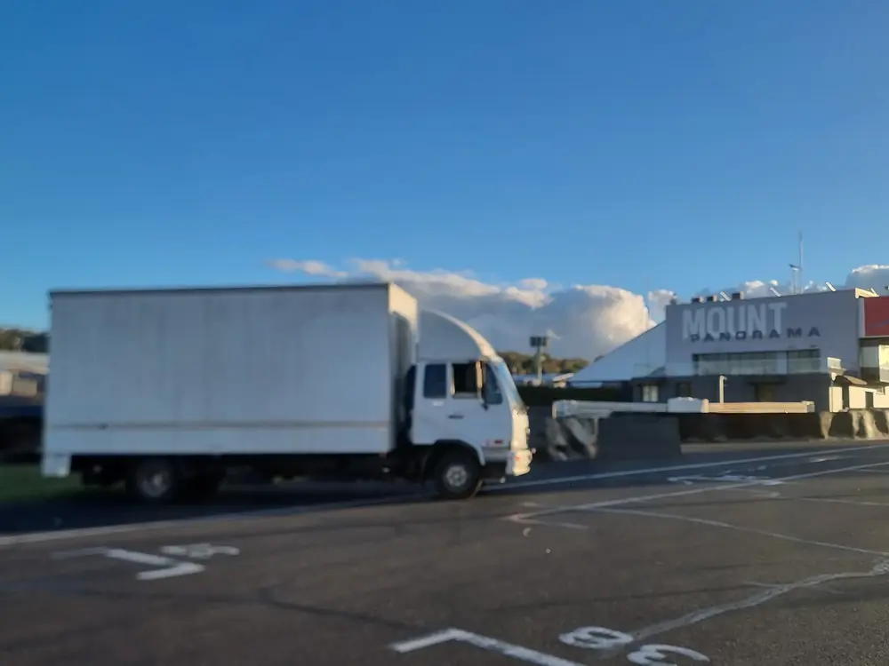 White box truck parked near Mount Panorama